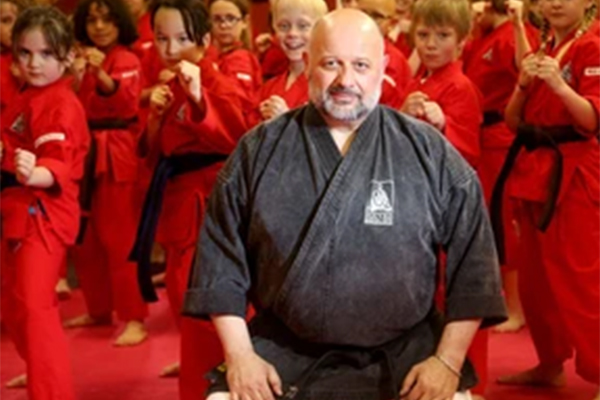 Master John Douvris standing in front of his students