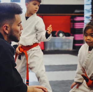 Sensei Sebastian talking to a young karate kid