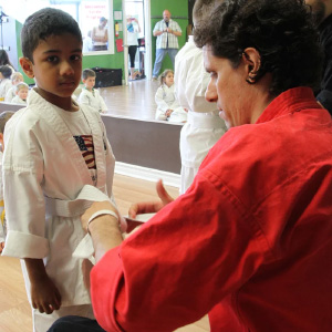 Riverside-South member with instructor tying belt